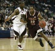 SOUTHERN ILLINOIS' WESLEY CLEMMONS, LEFT, slows down Virginia Tech's Jamon Gordon during a second- round showdown at the NCAA Tournament. The Salukis, who beat the Hokies, 63-48, on Sunday to advance to the Sweet 16, have limited opponents to just 61.6 points per game this season.