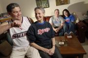 William and Mary McGuinness, Lawrence, foreground, are both graduates of Southern Illinois University and big fans of the Jayhawks. All their children have attended KU, including their daughter Eilish, a freshman, pictured at far right with her boyfriend, Jimmy Golden. William is wearing a Saluki jersey given to him by a son and pretends to snub his family&squot;s allegiance to the Jayhawks. "We&squot;re all total, true blue, Jayhawk fans," Mary said.