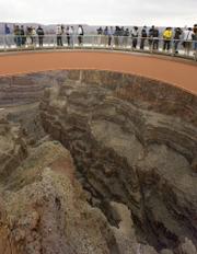 People walk on the Skywalk during the First Walk event Tuesday at the Grand Canyon on the Hualapai Indian Reservation at Grand Canyon West, Ariz. The Skywalk opens to the general public March 28.
