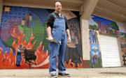 David Loewenstein, a local muralist, stands by one of his works at Hobbs Park ballfield in East Lawrence. Loewenstein and leaders of the Spencer Museum of Art at Kansas University hope the city will approve a downtown mural project to honor black artists from Kansas, such as Langston Hughes and Gordon Parks.