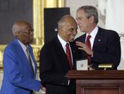 President Bush greets Tuskegee Airmen Alexander Jefferson, left, and Roscoe Brown. They and other Tuskegee Airmen received the Congressional Gold Medal during a ceremony Thursday in the Capitol Rotunda in Washington, D.C.
