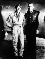 Famed aviator Amelia Earhart and her navigator, Fred Noonan, pose in front of their twin-engine Lockheed Electra in Los Angeles at the end of May 1937 before their historic flight in which Earhart was attempting to become the first female pilot to circle the globe.