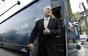 U.S. Sen. John McCain, R-Ariz., steps off his campaign bus after arriving at the Iowa Statehouse on March 15. This year's presidential candidates are driving more hybrid and flex-fuel vehicles to save energy while on the campaign trail.