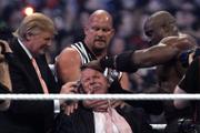WWE Chairman Vince McMahon, center, held by "Stone Cold" Steve Austin, has his hair cut off by Donald Trump, left, and Bobby Lashley, right, after Lashley defeated Umaga at Wrestlemania 23 Sunday at Ford Field in Detroit.