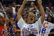 UNIVERSITY OF FLORIDA STUDENT CLAUDIA MURRAY gets in the swing of things at the O'Connell Center in Gainesville, Fla., while watching the Gators beat Ohio State for the NCAA national championship.