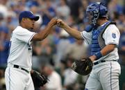 KANSAS CITY ROYALS RELIEVER JOEL PERALTA, LEFT, is congratulated by John Buck after putting the wraps on an Opening Day victory against the Boston Red Sox. The Royals earned a 7-1 triumph Monday at Kauffman Stadium in Kansas City, Mo.