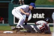 BOSTON'S DUSTIN PEDROIA IS TAGGED OUT by Kansas City second baseman Mark Grudzielanek as he tries to stretch a single into a double. The Royals knocked off the Red Sox, 7-1, in Monday's season opener at Kauffman Stadium in Kansas City, Mo.