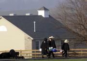 Amish Children make their way to their newly constructed schoolhouse, built to replace the razed West Nickel Mines Amish School, where a gunman killed five students and himself in October 2006. Students who survived the shooting moved into the new building Monday, six months to the day after the massacre.