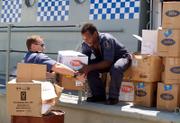 A member of the Australian Navy, left, helps a Solomon Islands police officer load relief supplies for the tsunami-battered region of Gizo onto a ship in Honiara, Solomon Islands. A powerful magnitude 8.0 earthquake struck early Monday off the Solomon Islands, creating a tsunami in the islands' Western Province.