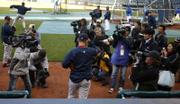 Boston pitcher Daisuke Matsuzaka walks out of the dugout as a crowd of Japanese and American media cover his entrance before the Royals' 7-1 loss Wednesday. Matsuzaka will make his major-league debut tonight.