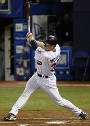 Minnesota's Justin Morneau connects for a home run. The Twins defeated Baltimore, 3-2, on Tuesday night in Minneapolis.