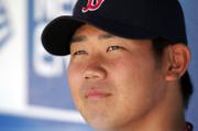 Daisuke Matsuzaka observes pregame activities from the dugout prior to the opening-day game between Kansas City and Boston on Monday in Kansas City, Mo.