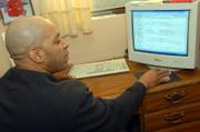 Devin James, creator of a new crime newspaper, JAIL, searches online through a jail booking log from his home in Orlando, Fla. JAIL features nothing but mug shots from arrests in a three-county area of Florida.
