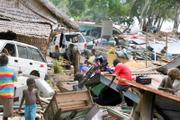 Villagers retrieve items from the ruins of Gizo, Solomon Islands. Relief workers who reached the area Wednesday warned that disease outbreaks were possible, while ruined infrastructure hampered efforts to get aid to survivors running low on food and water.