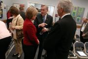 U.S. reps. Dennis Moore, D-Kansas, center, and Nancy Boyda, D-Kansas, talk with Blake West, president of the Kansas National Education Association before Thursday's community meeting to address problems and concerns with the No Child Left Behind law at the Lawrence public schools administrative office, 110 McDonald Drive. Local educators, administrators and parents attended the meeting to voice their ideas on education in Kansas. The event was part of Moore's districtwide "No Child Left Behind Listening Tour."