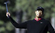 Tiger Woods reacts to a missed birdie put on the 14th green. Woods eagled the 13th hole and looked poised for another back-nine charge, but he failed to catch leader Zach Johnson, who watched from the locker room.