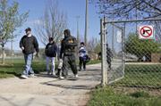 Kansas University senior Tyler Staples, Kansas City, Kan., left, and Jeremy Woods, right, leave Holcom Sports Complex after leading tryouts for the Lawrence Dynasty, a youth baseball team. Kansas lawmakers intend to amend the concealed-carry bill so that cities cannot ban firearms at outdoor youth sports venues.