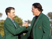 Zach Johnson, left, is congratulated by last year's champion, Phil Mickelson, during the green-jacket ceremony. Johnson won the 2007 Masters on Sunday in Augusta, Ga.