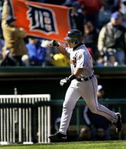 Detroit's Ivan Rodriguez rounds the bases after hitting a three-run home run. Rodriguez's ninth-inning blast provided the Tigers' only runs Sunday, but it was enough to edge the Royals, 3-2, in Kansas City, Mo.