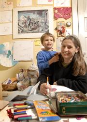 Lora Jost and her son Nicholai Jost-Epp, 5, also are part of the exhibit, which explores the connection between art and mothering. Jost and her son are pictured in a space that Nicholai uses to do his artwork.
