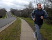 Toby Eastland, who will be running in the Lawrence Half-Marathon on Sunday, runs Wednesday along South Inverness Drive. "I have been training since November and I'm excited to run a race that's proceeds will go to help people who don't have health insurance" Eastland said. The Lawrence Half-Marathon & 5K will take place this year instead of the Raintree Run.