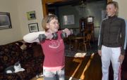 Sue Kapfer, left, who has multiple sclerosis, does some exercises with free weights with her personal trainer, Becky Bridson. Kapfer has been working with Bridson for more than a year and has increased her strength and coordination.