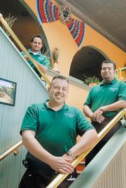 Cielito Lindo's Jose "Pepe" Lopez, foreground, co-owner David Valadez, right, and server Rene Garcia, left, are
pictured inside the downtown restaurant.
