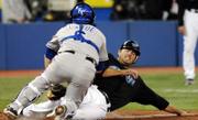 Kansas City catcher Jason Larue, left, tags out Toronto's Troy Glaus. The Blue Jays defeated the Royals, 7-4, on Wednesday night in Toronto.