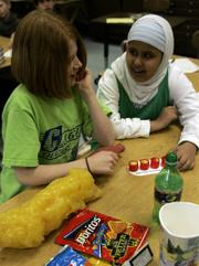 Clague Middle School students Jessa Gargan, left, and Zahra Al-hasnawy look over props used in a health program in their classroom in Ann Arbor, Mich. Healthy Schools, a collaborative program between Ann Arbor public schools and the University of Michigan Health System, teaches basic nutrition information and encourages physical exercise.