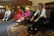 Pioneer Ridge Retirement Community residents, from left, Les Davis, Beverly Edwards, Josephine Mummert and Lucille Lamer stretch during an afternoon workout in the activities room on Thursday. Moving into a long-term care facility can contribute to depression in older adults, but officials say efforts are being made to keep residents active and and help them cope as their lives change.