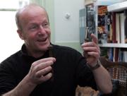 British novelist Jim Crace uses a rusted bolt to illustrate the impermanence of technology during an interview in London. Crace's newest work, "The Pesthouse," envisions a post-apocalyptic America in which survivors emigrate to Europe.