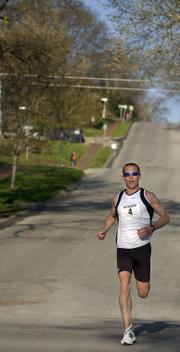 Jason McCullough, Fort Hays State track and field coach, runs downhill during the Lawrence Half-Marathon. McCullough won the race Sunday.