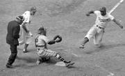Brooklyn Dodgers' Jackie Robinson, right, steals home plate after Boston Braves catcher Bill Salkeld is thrown off-balance Aug. 22, 1948, at Ebbets Field in New York.