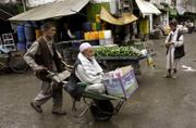 An elderly Afghan man is carried on a push cart at a market in Kabul, Afghanistan. Insurgents have committed war crimes by attacking ordinary Afghans and killed 669 civilians in 2006, the heaviest toll since the Taliban's ouster in 2001, according to a report released Monday.