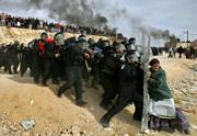 A Jewish settler struggles with an Israeli security officer during clashes that erupted as authorities evacuated the West Bank settlement outpost of Amona, east of the Palestinian town of Ramallah, in this February 2006 photo. Oded Balilty of The Associated Press won the Pulitzer Prize for breaking news photography for his image of a lone Jewish woman defying Israeli security forces as they remove illegal settlers in the West Bank.