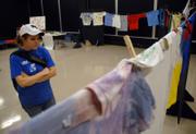 Kansas University junior Amelia Crowl, Emporia, reads a sleeve of a T-shirt that was decorated by an abuse victim for the annual Clothesline Project. T-shirts were displayed in Hashinger Hall to raise awareness of domestic abuse. The Clothesline Project is sponsored by Women's Transitional Care Services.