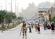 A massive cloud of Smoke rises from the scene where a suicide car bomber crashed into an Iraqi police checkpoint at an entrance to Sadr City, a Shiite district in Baghdad. Four large bombs exploded in mostly Shiite areas across Baghdad on Wednesday, killing more than 180 people as violence climbed toward levels not seen since the U.S.-Iraqi campaign to pacify the capital began two months ago.