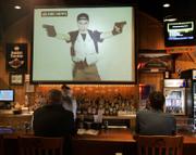 Blacksburg, Va., customers watch the NBC Nightly News as they dine in a local restaurant. Between his first and second bursts of gunfire, Virginia Tech gunman Cho Seung-Hui mailed a package to NBC that containing photos of him brandishing guns and video of him delivering an angry, profanity-laced tirade.