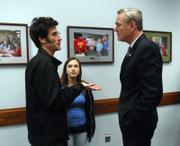 Jeffrey Kuhr, left, and Alexia Welch approached Rep. Dennis Moore recently at the USD 497 Administrative Offices, inviting him to the screening of "No Child Left Unrecruited."