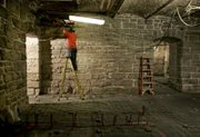 A worker installs new plumbing April 12 in the basement of the west wing of the Kansas Statehouse in Topeka. The work is part of ongoing renovations at the Statehouse that are expected to cost more than $200 million before all phases are completed in 2011.