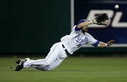 KANSAS CITY ROYALS LEFT FIELDER ROSS GLOAD, makes a diving catch on a fly ball hit by the Chicago White Sox's Darin Erstad, only to have it not count after Royals catcher John Buck was called for catcher's interference on the play.