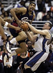 Cleveland's Drew Gooden, left, fights for possession with Washington's Darius Songaila. The Cavaliers defeated the Wizards, 98-92, on Saturday in Washington to take a 3-0 lead in their series.