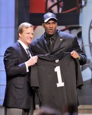 JAMARCUS RUSSELL, RIGHT, stands with NFL commissioner Roger Goodell after the Oakland Raiders made the quarterback out of LSU the top pick in the NFL Draft. The first three rounds of the draft were completed Saturday in New York.