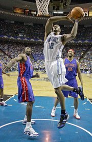 Orlando's Dwight Howard (22) dunks over Detroit's Antonio McDyess, left, and Rasheed Wallace. The Pistons defeated the Magic, 97-93, on Saturday in Orlando, Fla., to sweep their first-round series.