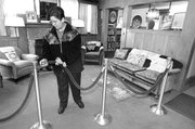 Volunteer Judy Cantrell secures a velvet rope while cleaning in the former living room of author Laura Ingalls Wilder at the late author&squot;s home in February in Mansfield, Mo. Seventy-five years after the first of Wilder&squot;s "Little House" novels was published, the books remain popular internationally.
