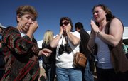 Jennifer Gorman, from left, with David Gorman's sister, Marilyn Larson and niece Eileen Whitesides attend the launch of a rocket carrying ashes from several people, including actor James Doohan and Jennifer's late husband, David Gorman, into space Saturday from Upham, N.M.