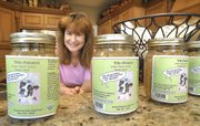 Victoria McDowell, owner of Miss Autumn's Barkery, displays a selection of her company's organic dog food in her kitchen in Jackson, Mo. McDowell started the business after her terrier died of cancer and she researched ingredients in pet food.