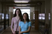 Lawrence High School seniors Rebecca Dirks, left, and Baoqing Zhou are recipients of $2,500 scholarships from the National Merit Corp. Both are considering pursuing careers in chemistry.