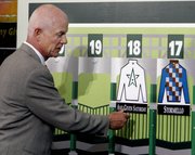 WINSTAR FARM PRESIDENT Bill Castner hangs the silks for his Kentucky Derby entrant, Any Given Saturday. The post position draw for the Derby was Wednesday in Louisville, Ky.
