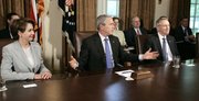 President Bush, center, flanked by House Speaker Nancy Pelosi, of California, left, and Senate Majority Leader Harry Reid, of Nevada, meets with congressional leaders regarding a new bill to fund the war in Iraq. Presidential adviser Karl Rove is seen seated behind Bush and Reid.